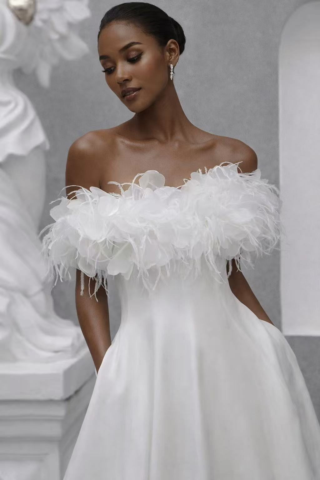 White elegant dress decorated with  ostrich feather